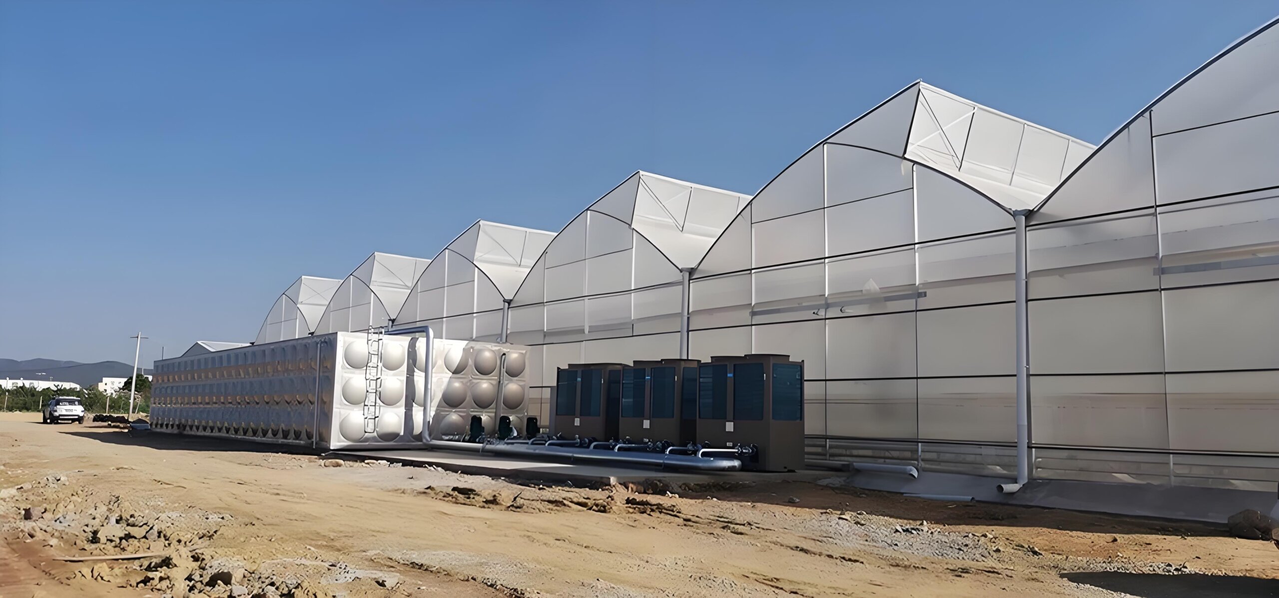 Exterior view of a modern sawtooth-style greenhouse block with strong architectural rhythm. Good for hero, engineering, and structure-focused copy. greenhouse exterior for commercial greenhouse RFQ checklist