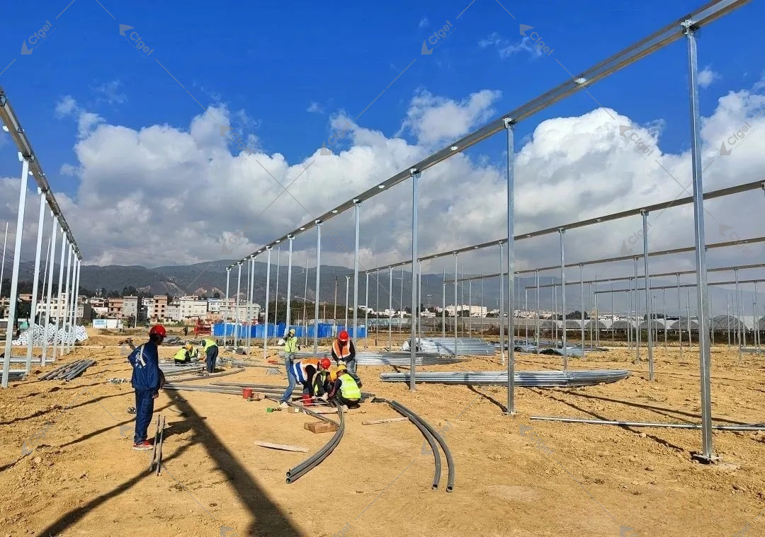 Inspect coating thickness, bare cut edges, base details, stored members, and damaged areas before the covering hides access to the steelwork. Galvanized greenhouse columns and beams during site installation