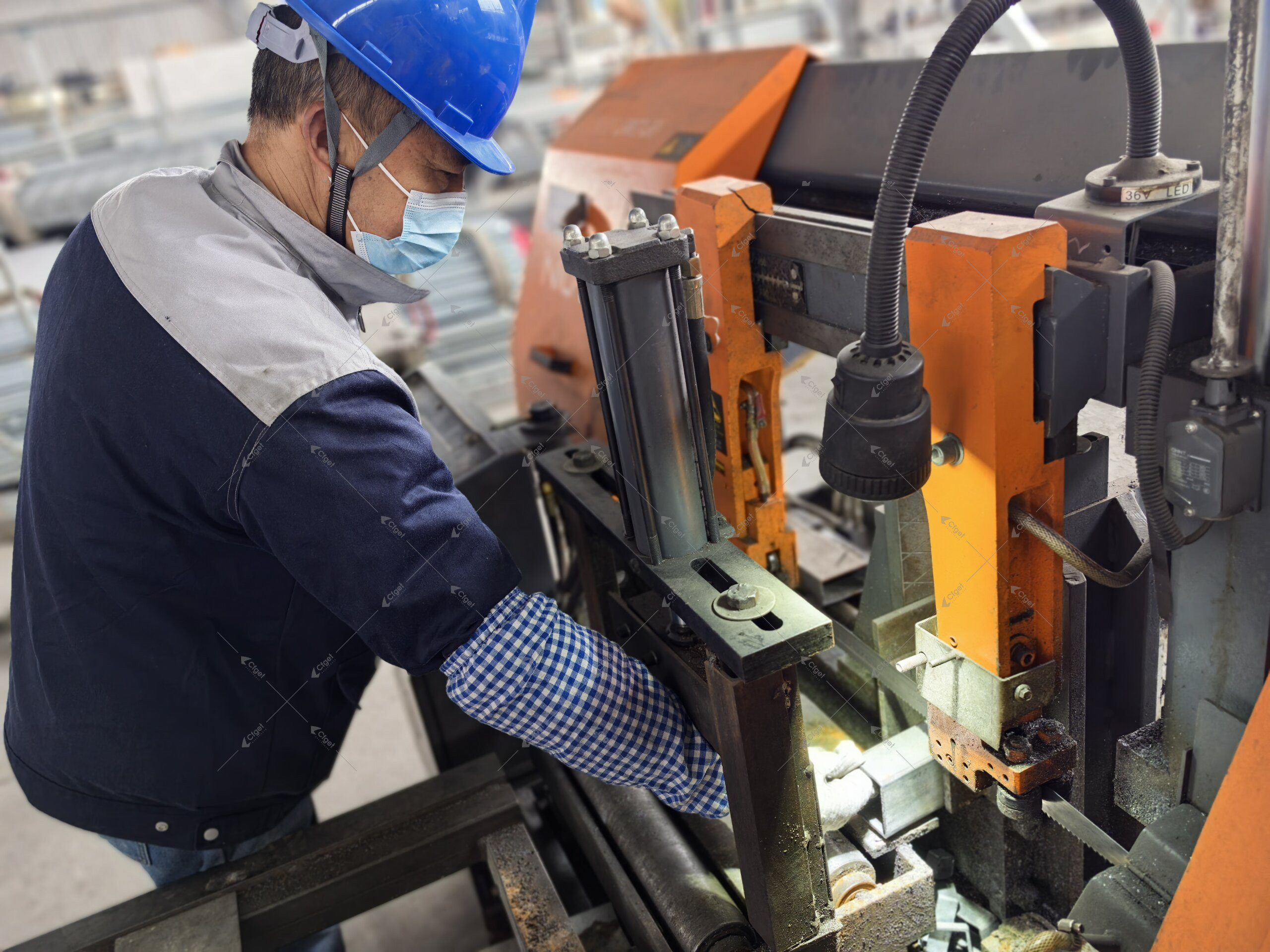 Fabrication records should identify material grade, coating route, drilling or cutting after galvanizing, and how exposed steel is repaired and inspected. CFGET factory worker cutting greenhouse steel components
